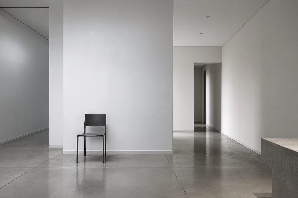 A perfectly tidy but cold-feeling minimalist room with bare walls
